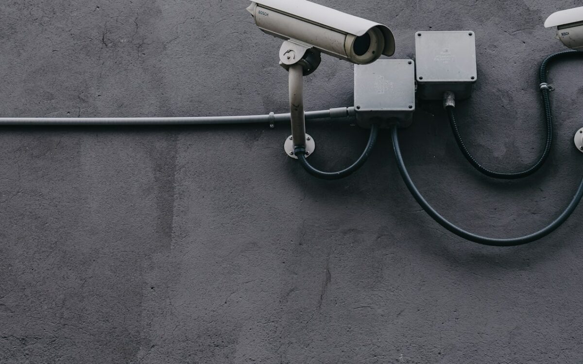 Two bullet CCTV cameras mounted on a rendered wall
