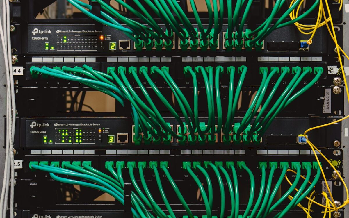 Neatly patched green network cables in a rack